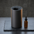 Siweiyi black mini USB oil spray machine, photorealistic dark-premium packshot