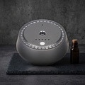 Vossa Sense motion-activated car diffuser standing upright, photorealistic dark-premium packshot